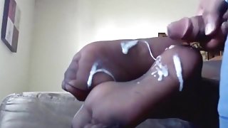 Black guy gets a footjob for his gf and he cums on her feet