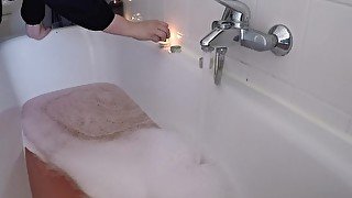 Amateur teen plays with her huge boobs in a got bath