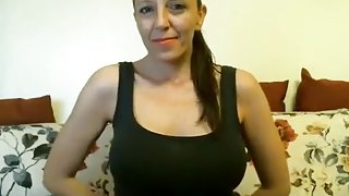 Busty brunette milf with big tits smoking and stripping on webcam