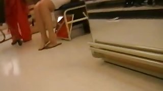 A sexy middle aged woman in a tight white dress voyeur video
