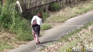 Naughty Japanese chicks crouch and take a piss outdoor