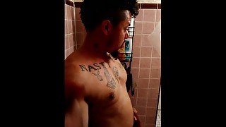 Sexy guy taking shower at the gym