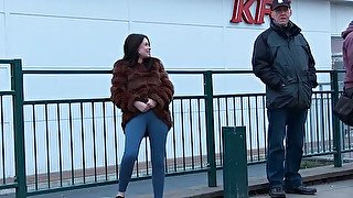 Kinky amateur brunette in fur coat pisses outdoors and makes her jeans wet