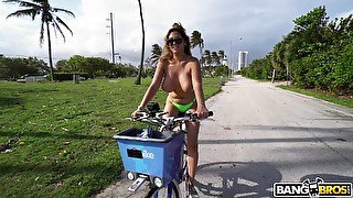 Dirty cougar Jazmyn rides a bike topless and gets fucked good