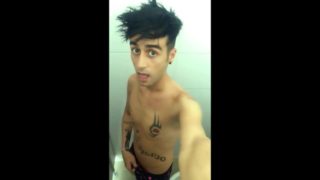 Tattooed twink is pissing in waterpark piss filled toilet