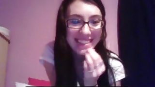 Nerdy brunette girl with glasses masturbates with a dildo for her bf on skype