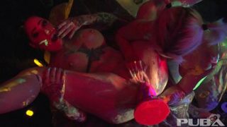 Black-light babes Nadia and Ophelia suck off a colorful cock