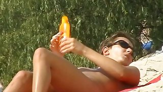 A luscious woman sunbathing in this nude beach voyeur video