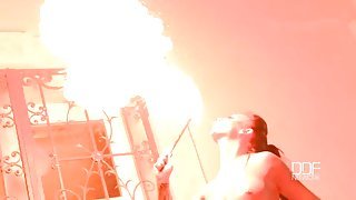 Topless big tits girl plays with fire