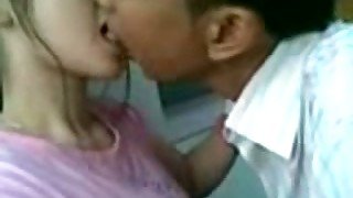 Lewd Asian couple kisses and spoons in a bit shy way on camera