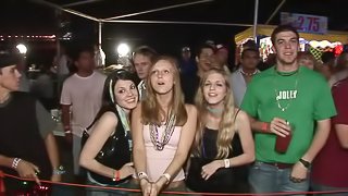 Some lewd chicks flash their tits and butts in a public place