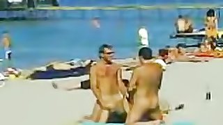 Two Guys and One Sexy Babe Have a Hot Threesome on a Nude Beach