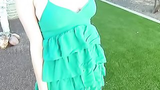Four-eyed brunette chick with huge boobies in green dress fingering her muff from behind