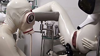 Latex doctor and latex patient on the gyno chair