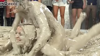 Wild brunette with a slim sexy body having a catfight in a mudbath