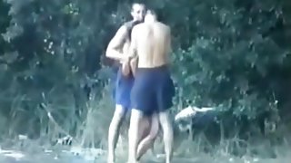 Voyeur tapes a slut having a threesome with 2 guys in the lake