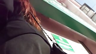 Hot redhead spied on by an up skirt perv