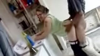 Amateur blond wearing glasses enjoys interracial rear sex in a kitchen