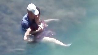 Voyeur captures a couple having sex in the sea