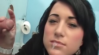 Sweater girl at the gloryhole gladly makes his cock cum
