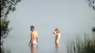 Homemade video of a couple swimming naked and fucking in the lake