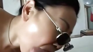 Asian girl with sunglasses sucks cock, while getting fingered.