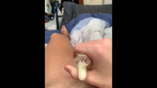 British teen jerks of naked with condom and busts his load in it. 