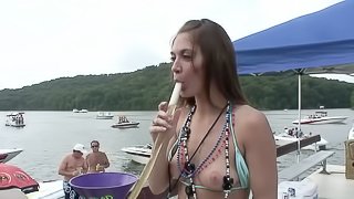 Showing her tits on the boat makes this cute brunette happy