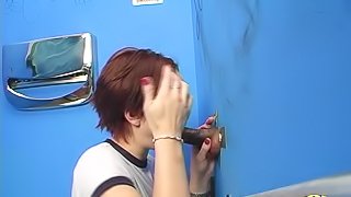 Short haired redhead takes a big black cock down her throat