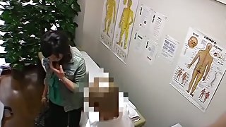 A plump Asian is showing her boobs and hairy pussy in the massage room