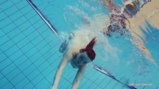 Redheaded Katrin stripping underwater
