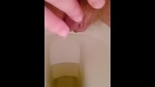 Playing with my hairy pussy while pissing on the toilet