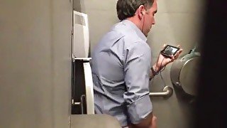 Stranger man in a public toilet filmed on a hidden camera