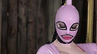 High heeled solo milf in latex dress and boots poses wearing a mask