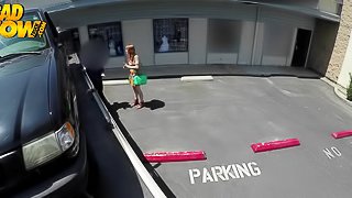 Redhead gives a guy head in the middle of a parking lot