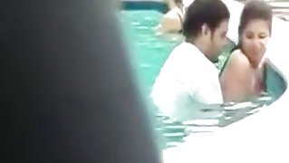 Pair copulates in public pool with people around 'em