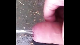 chav pissing and wanking in a field