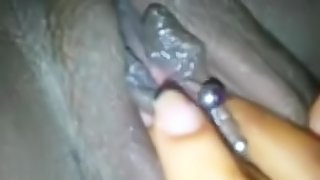 Kinky black chick fingers her soaking wet pierced twat