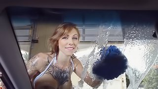 Big breasted lady is washing the car with her large tits