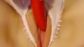 Nauhgyt abeb in white lingerie is masturbating with a red vibrator