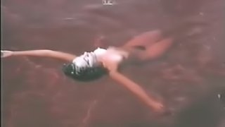 Delia Casanova Floating Naked in the Water