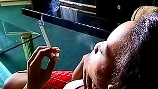 Black girl smokes cigarette solo