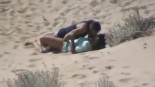 Amateur couple banging on a beach get caught on a voyeur's cam