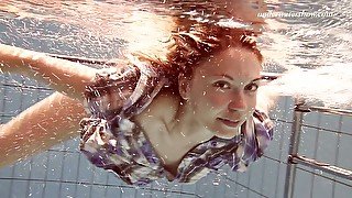 Adorable teen Iva Brizgina shows striptease under the water