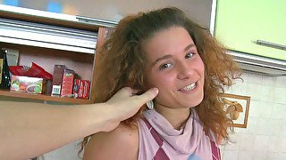 Playful redhead teen with curly hair eats sugary cock at the kitchen
