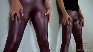 Mistress in RED leather leggings admires herself in the Mirror