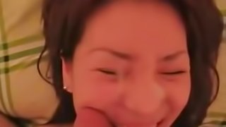 A pretty korean girl is filmed sucking a small cock and taking its cum all over her face
