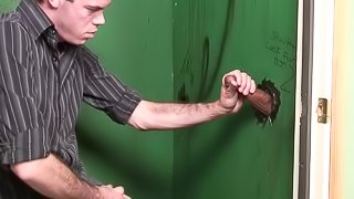 Gay guy sucks a rock hard cock at the gloryhole