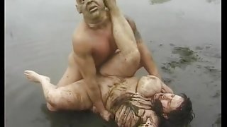 Masked man fucks a BBw in the mud