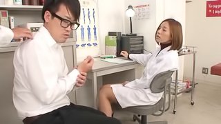 Doctor Ruri Saijo sits on a guy's cock while sucking another
